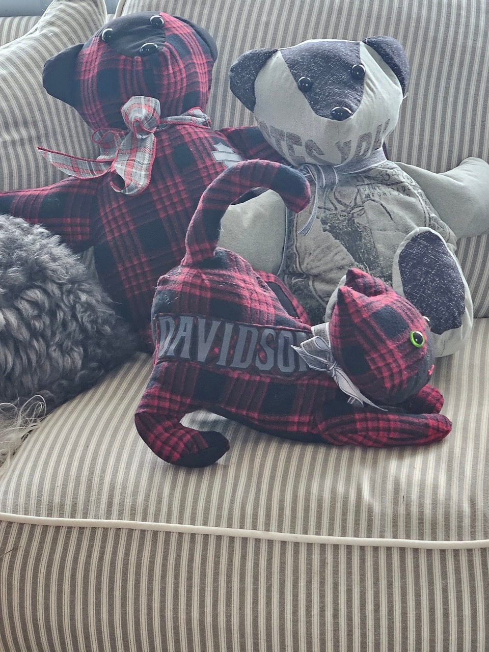 Memory keepsake bear, badger, and cat sewn from red plaid flannel and Harley-Davidson shirts