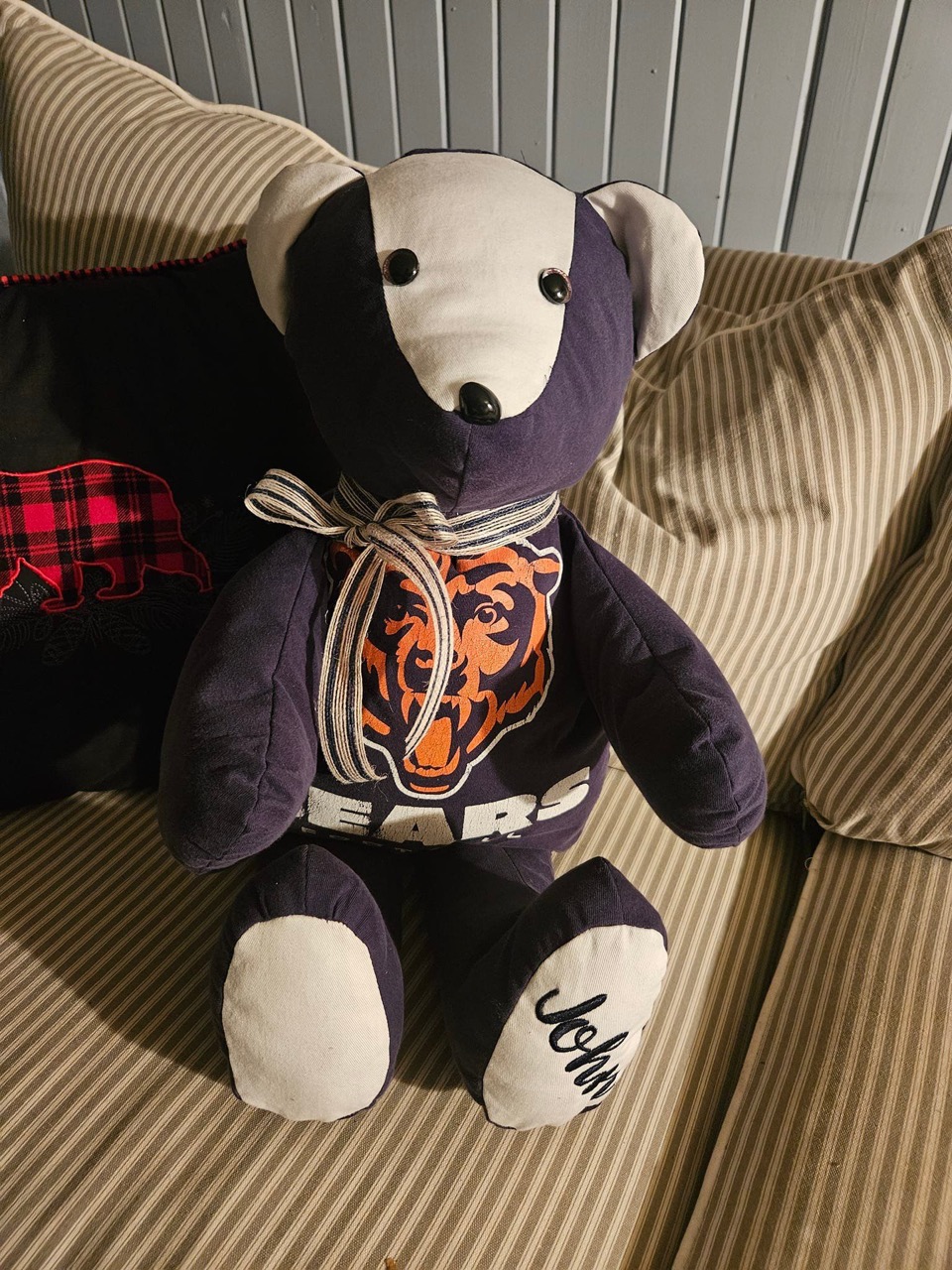 Memory keepsake bear sewn from a Chicago Bears shirt with a name embroidered on its foot