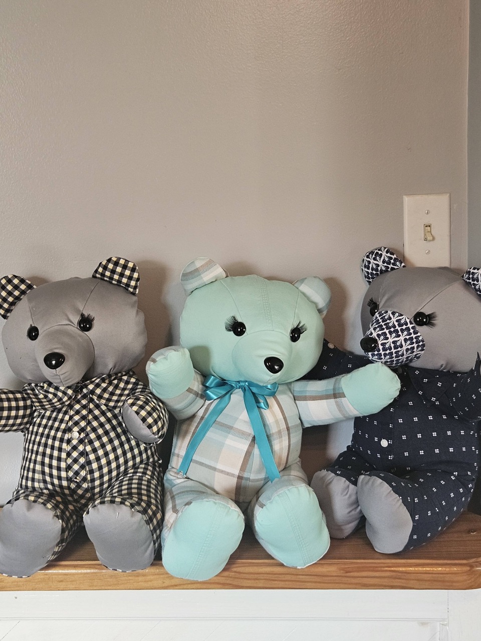 Three memory keepsake bears with stitched eyelashes, made from gingham, plaid, and navy shirts